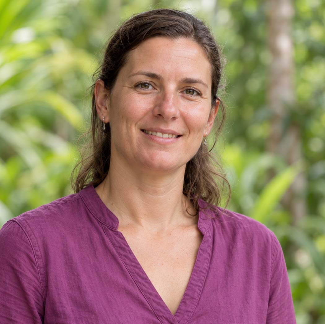 Team member in a purple shirt with brown hair tied back