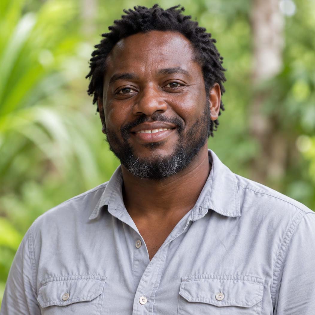 Team member in a light grey shirt with short black hair and a beard